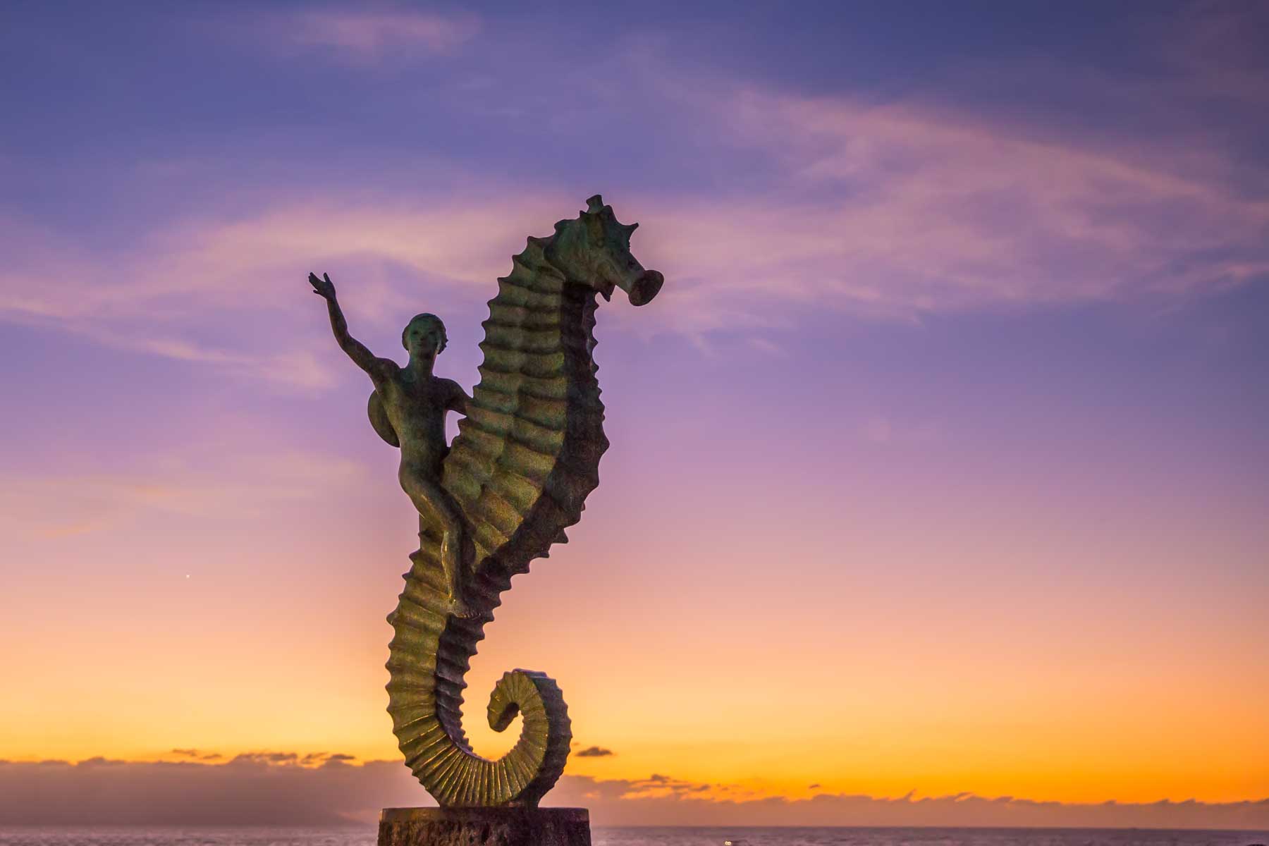 Malecon statue at sunset